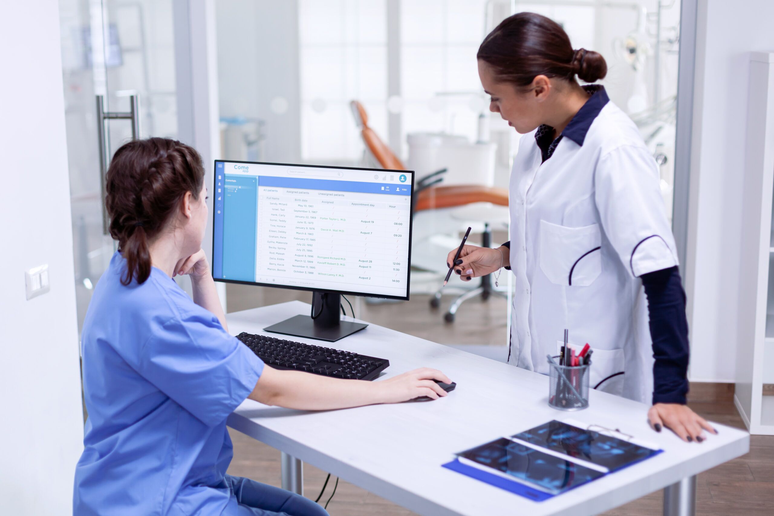 A dental care team reviewing appointment information