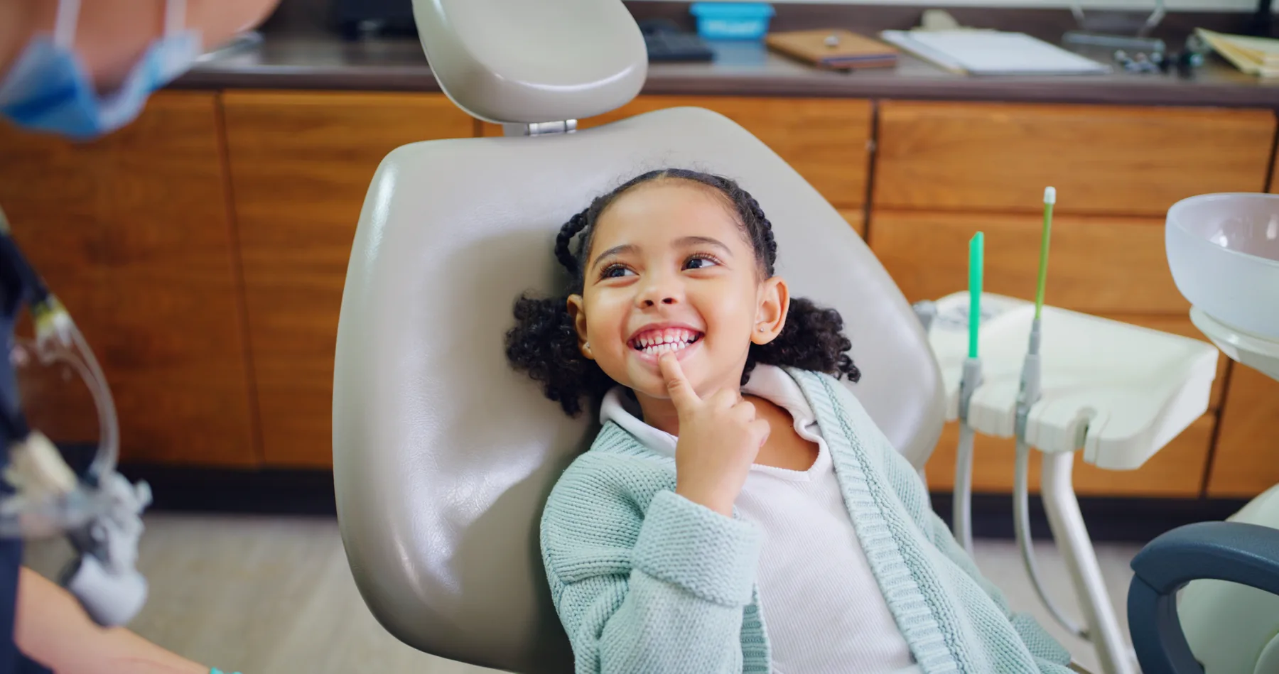 A smiling child showing her teeth during a comfortable dental visit