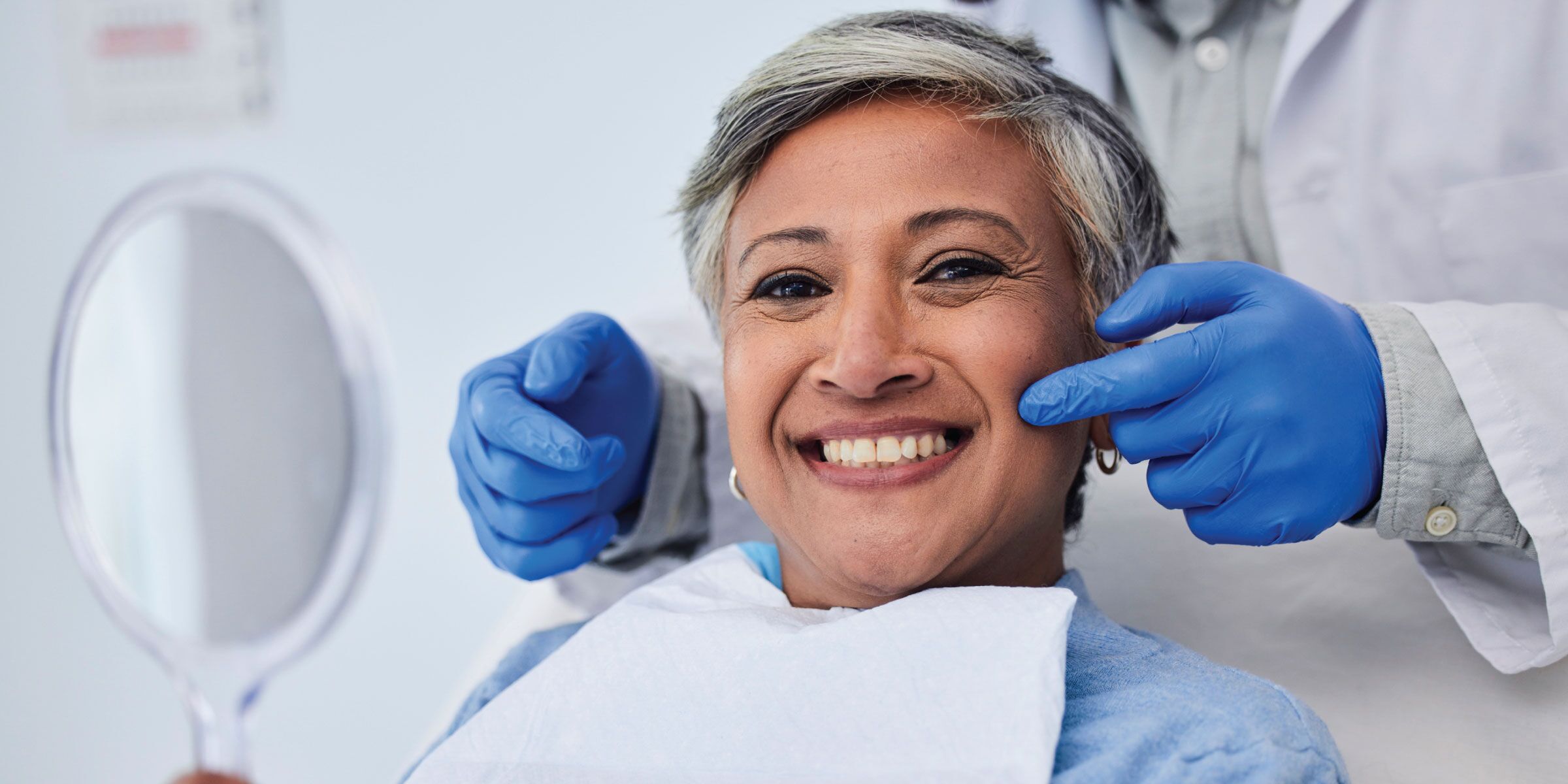An adult patient speaking with a dentist about replacing missing teeth